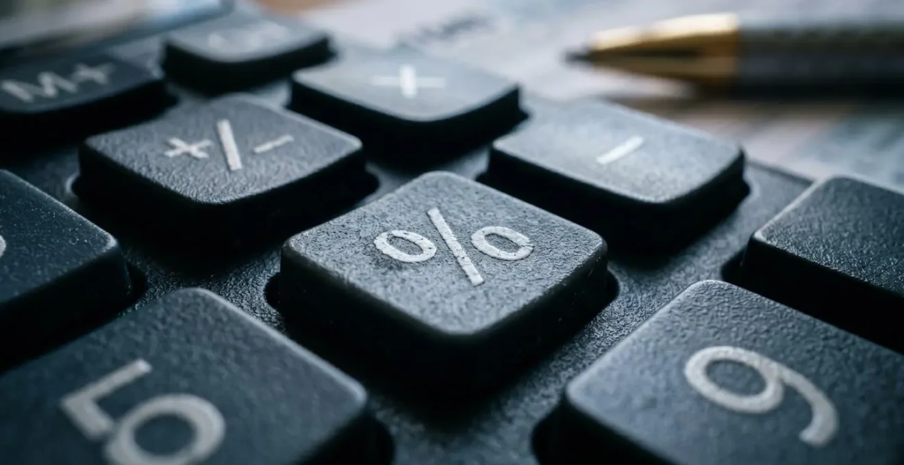Calculatrice et formulaires fiscaux sur bureau avec stylo et lunettes